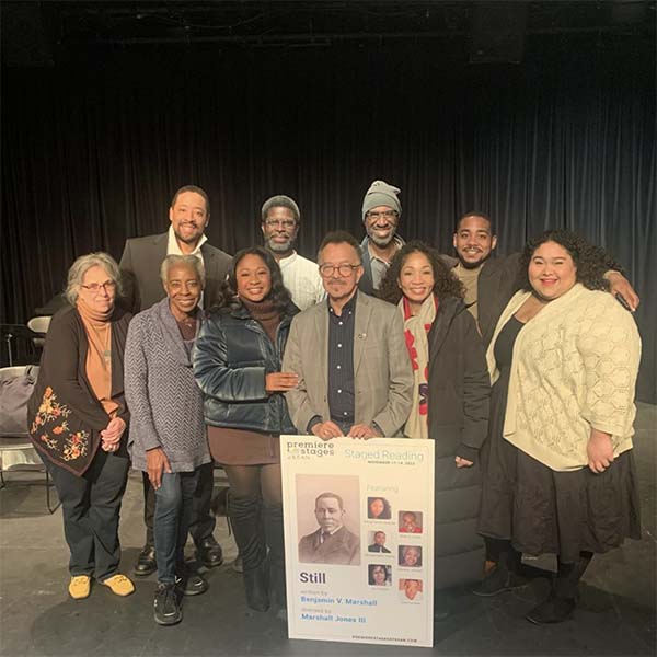 The staff and cast of STILL holding the poster of the staged reading