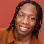 Christian's headshot wearing a brown shirt and a huge smile, against a red background