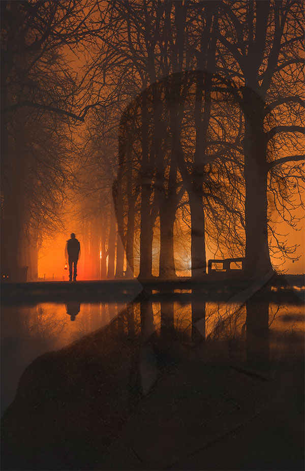 A man in the distance, holding a lantern and walking through a line of trees while the sun sets. His reflection is seen in the river in the foreground. A silhouette of an African American man can be seen through the trees.